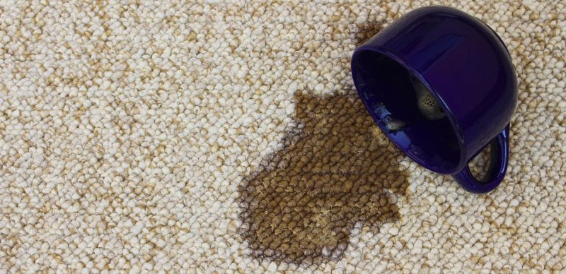 Coffee spilled from the cup on the carpet
