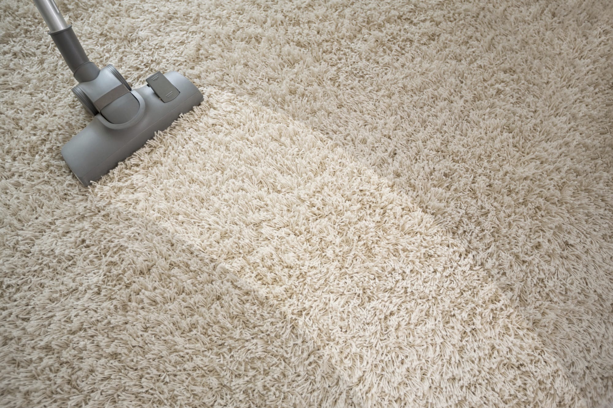 Vacuuming rough carpet with vacuum cleaner